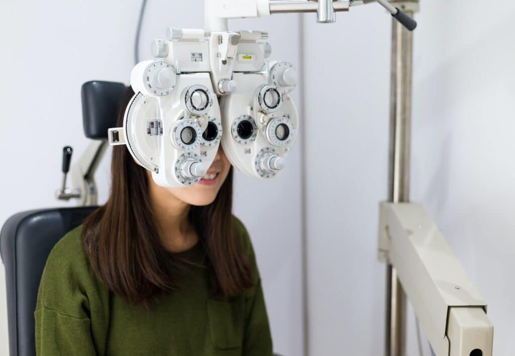 Woman checking on her eye with optometry machine